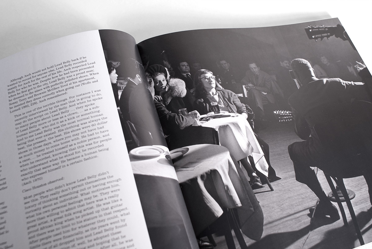 spread with full page photo of Lead Belly playing at a club